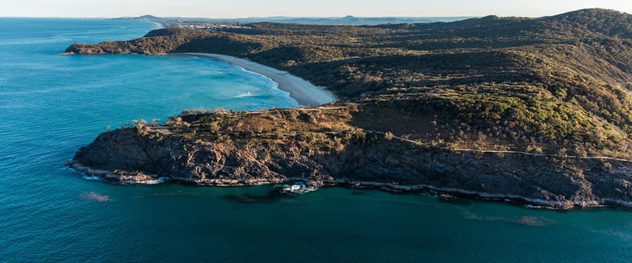 The Australian coastline from the air, with headland and beach